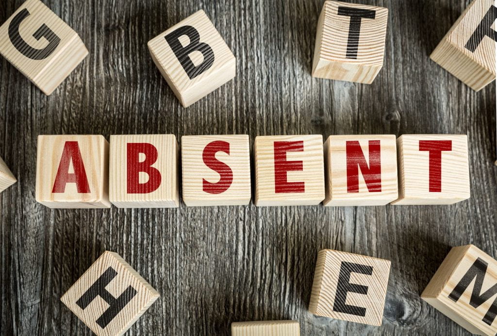 Wooden Blocks spelling the word  "Absent" 
